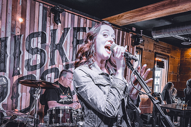 Woman singing with a band