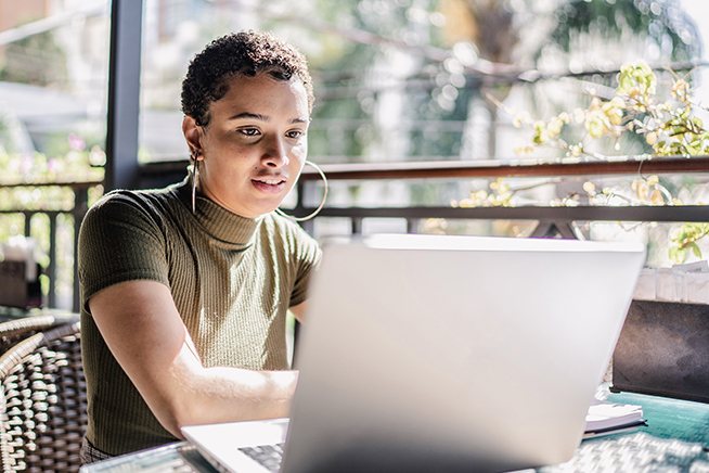 Woman looking at laptop. 