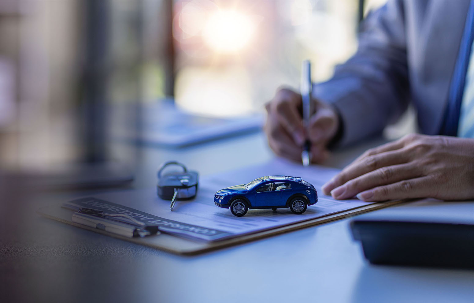 Toy car on table with official documents