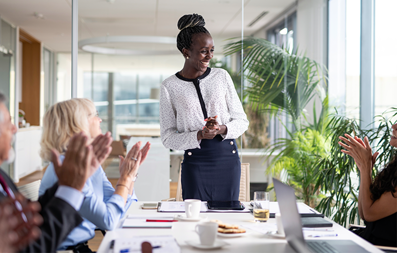 Woman is applauded in meeting
