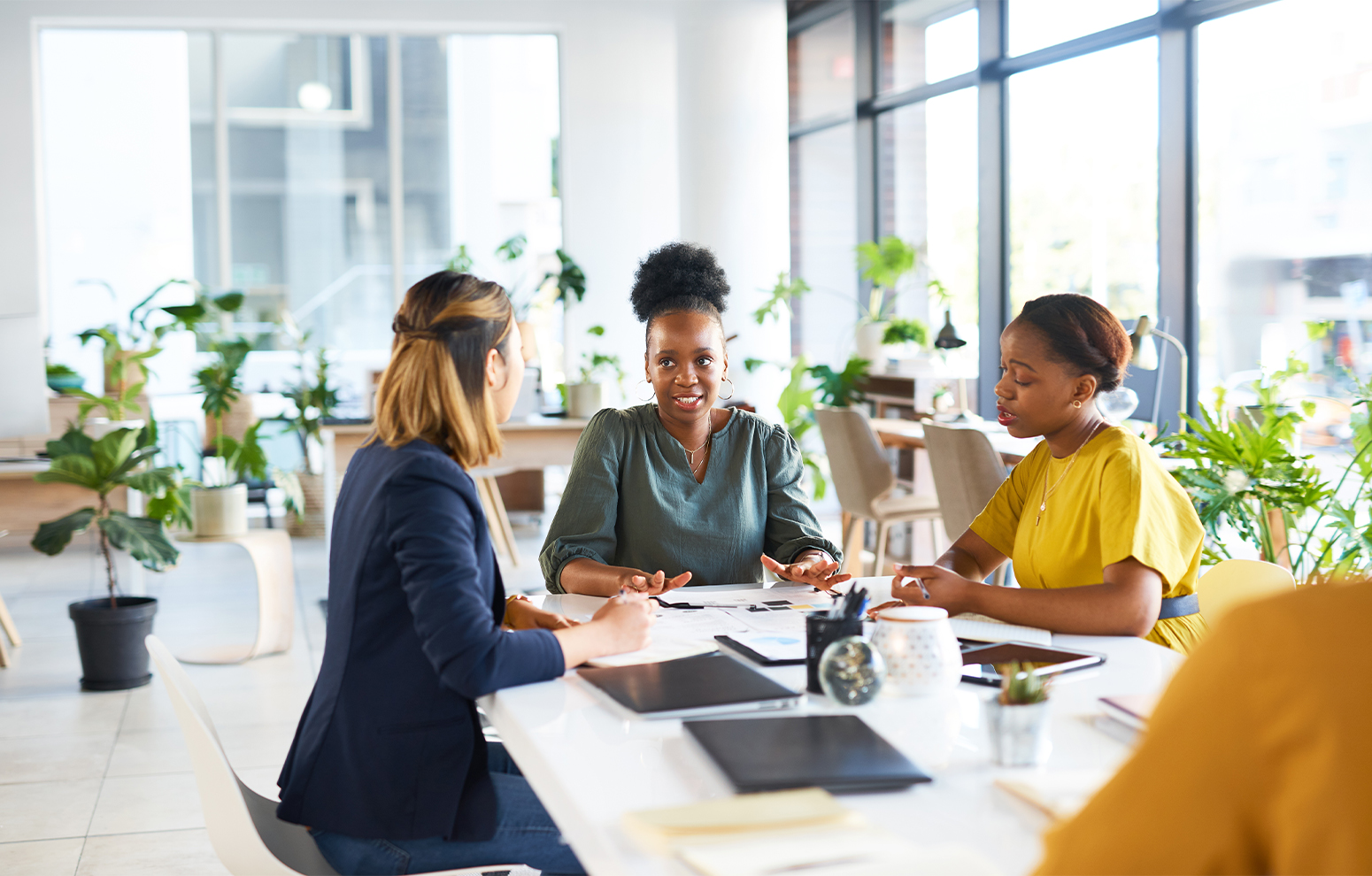 Woman sitting at large office table.