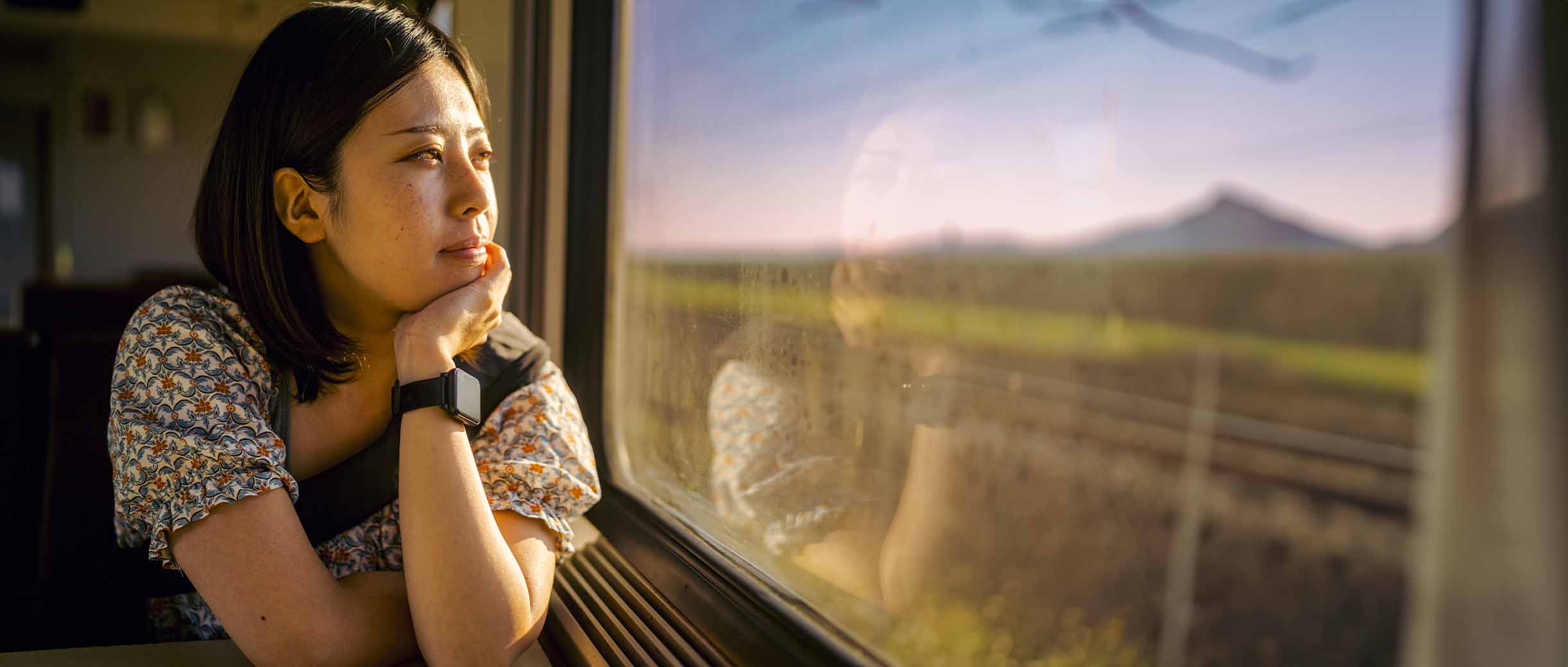 Woman looking out the window in a train.
