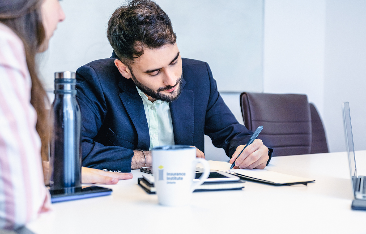 L'homme prend des notes lors d'une petite réunion.