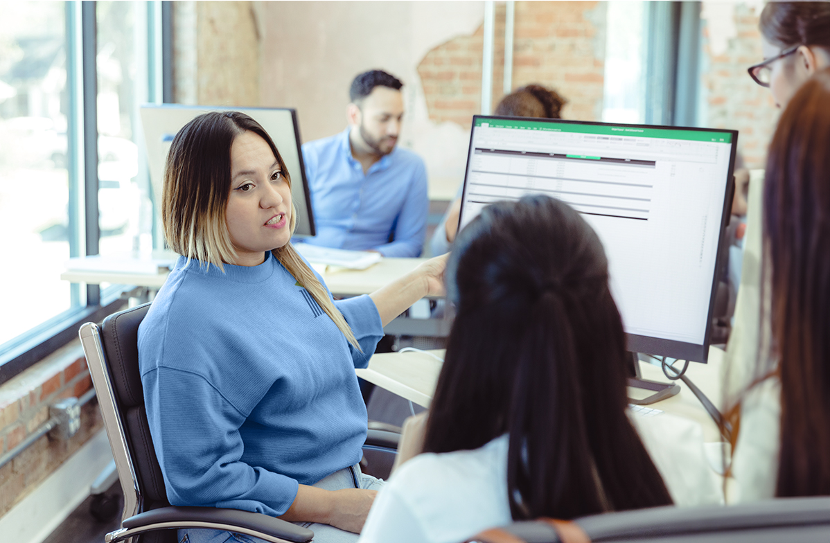 Two woman looking at a computer. 