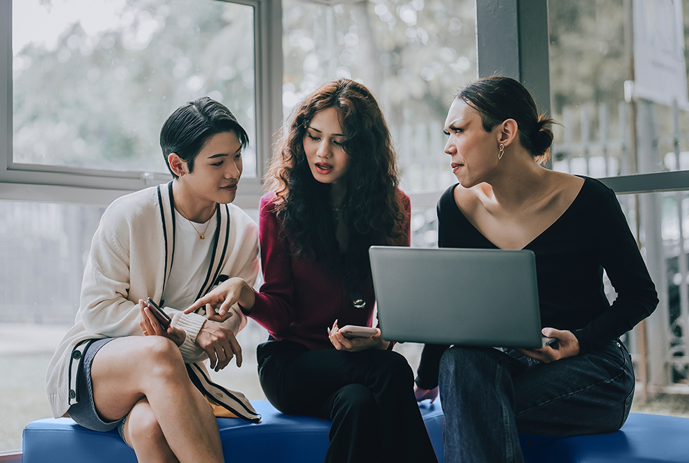 Group of people look at the computer.
