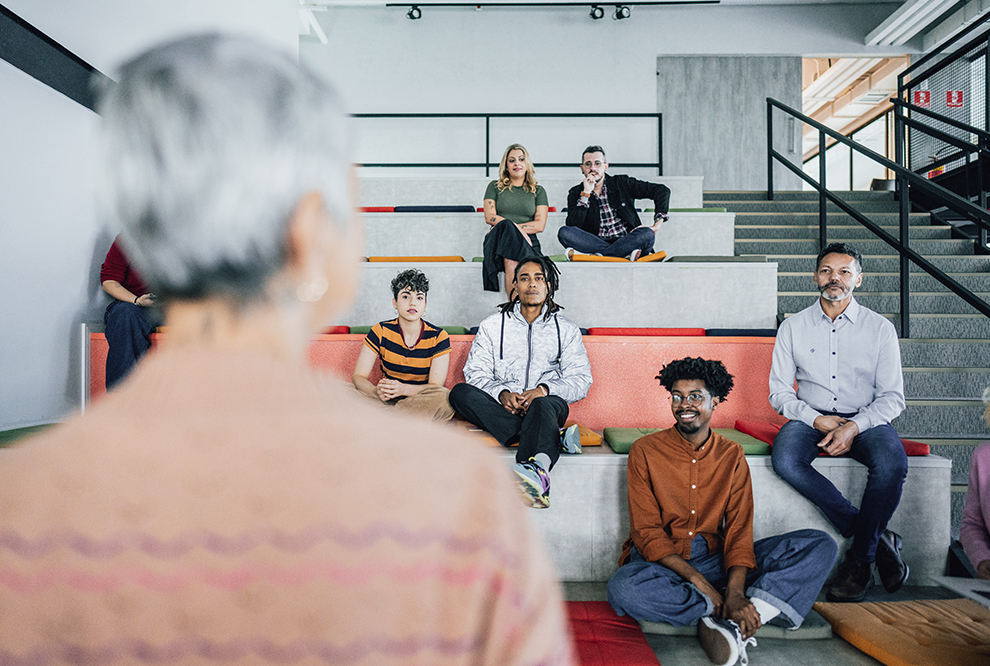 Teacher speaks to students in class. 